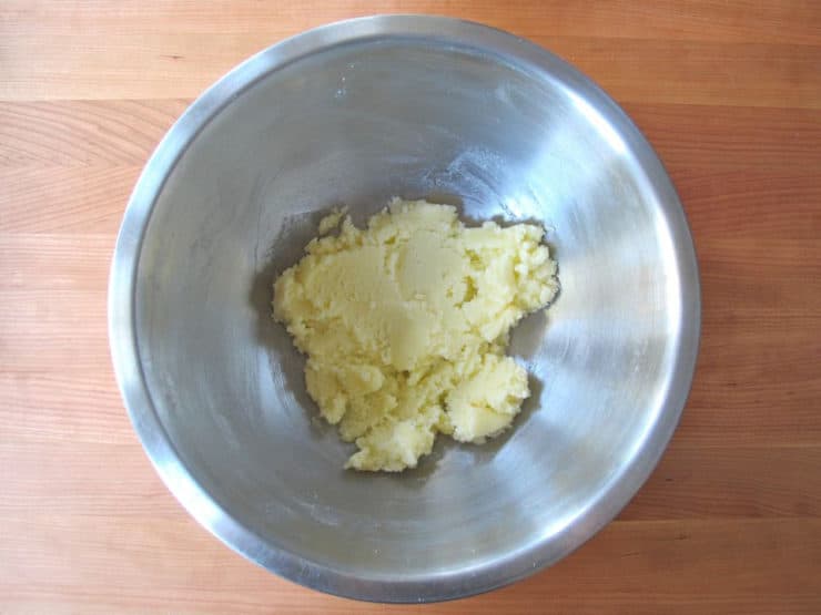 Creaming butter into sugar with a hand mixer.