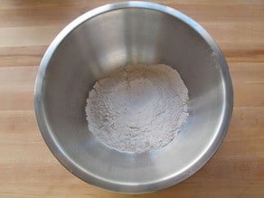 Dry cake ingredients sifted into a bowl.