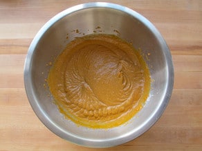 Dry and wet cake ingredients mixed together in a bowl.