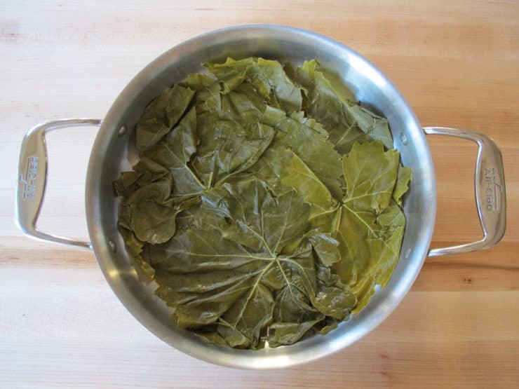 Place any torn grape leaves in the bottom of a stockpot.