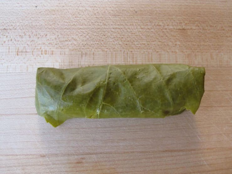Grape leaf rolled up over stuffing.