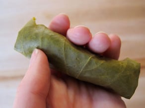 Gently squeeze grape leaf to seal.