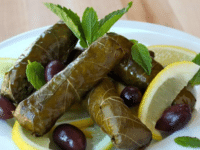 Delicious vegetarian stuffed grape leaves on a white plate