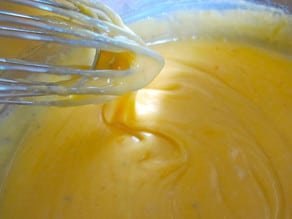 Melted cheese sauce in a saucepan.