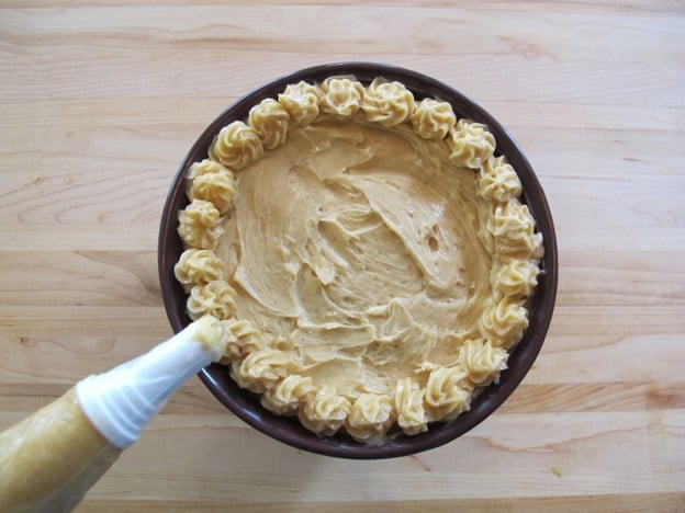 Piping stars of butter around edge of bowl.