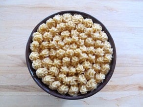 Bowl of butter covered with decorative stars of butter.
