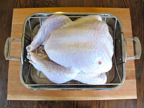 Brined turkey, rinsed and placed in a roasting pan.
