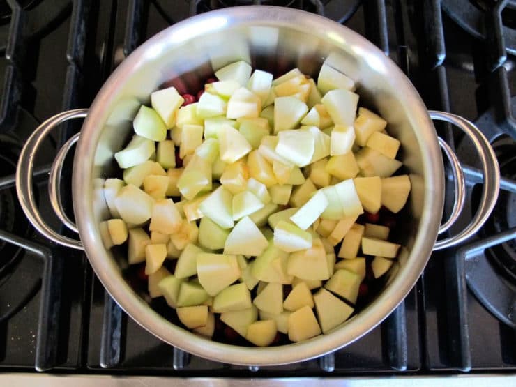 Peeled, diced apples in a stockpot.