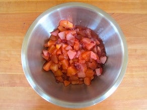 Cooked apples and cranberries in a bowl.