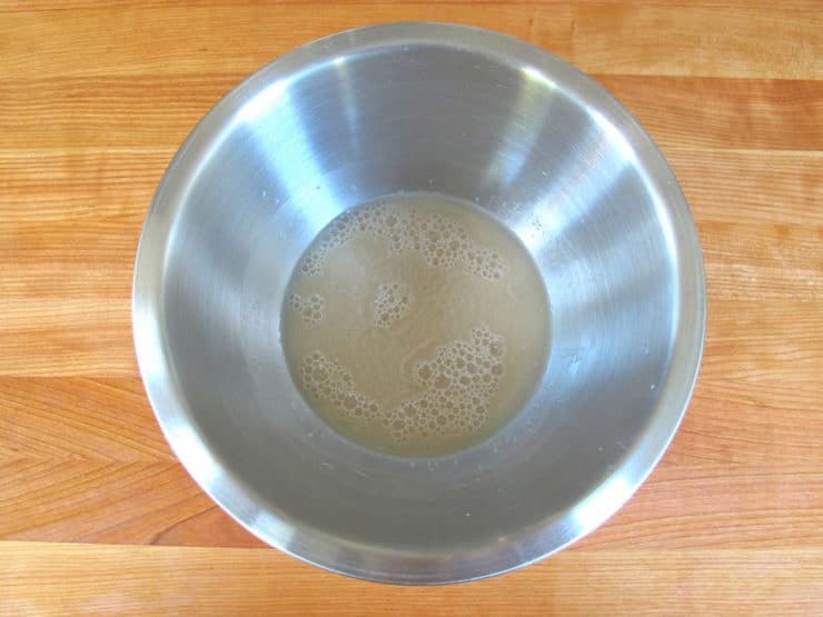 Whisk yeast into warm water in a large bowl.