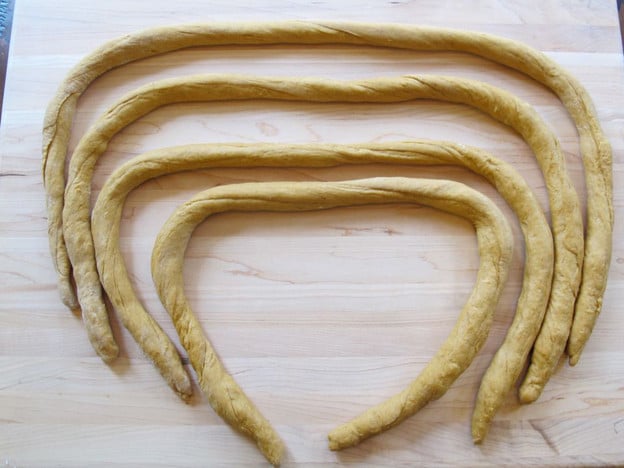 Challah dough rolled into long logs.