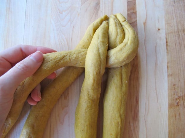 Braid the dough strands in an over under pattern.
