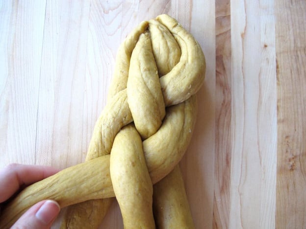 Braid the dough strands in an over under pattern.