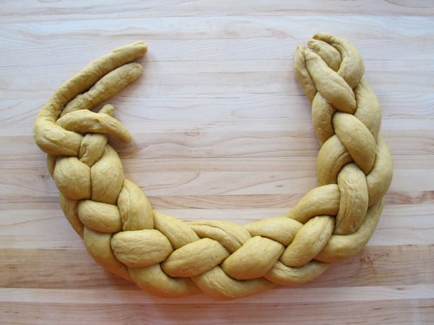 Braided challah in a rough circle.