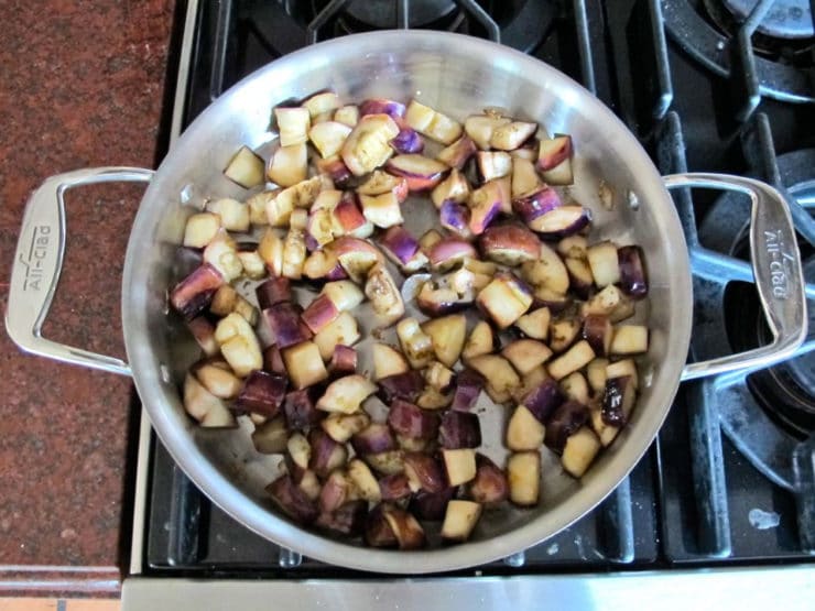 Cubed eggplant in a hot skillet.
