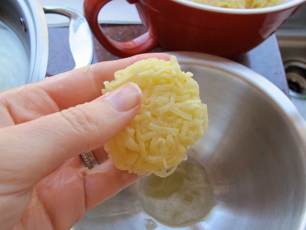 Shaping latkes into disks.