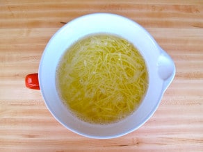 Shredded potatoes in cool water.