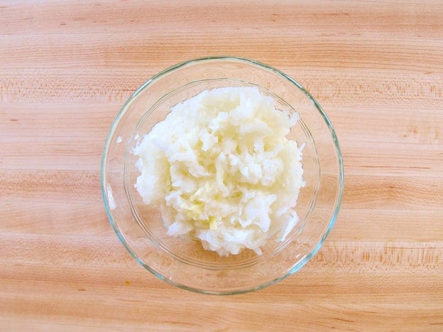 Shredded onion in a small bowl.