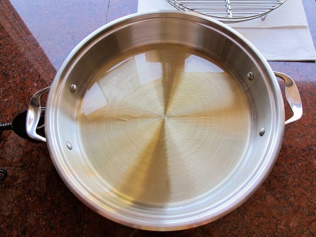 Heating oil in a pot for frying.