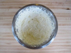 Water whipped into frosting in a bowl.
