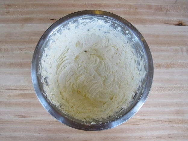 Water whipped into frosting in a bowl.