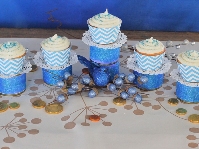 Cupcakes placed on olice cans in Menorah shape.