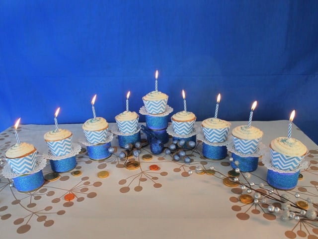 Menorah Cupcakes set up on the table with candles.