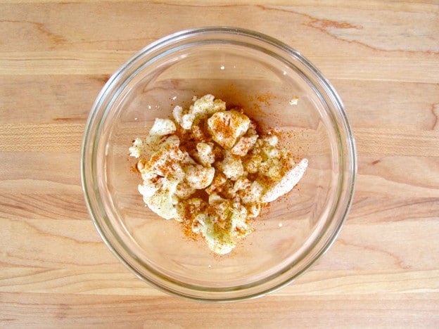 Scraps from cutting cauliflower in a bowl with oil.