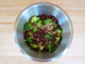 Broccoli, craisins, and sunflower seeds in a large bowl.