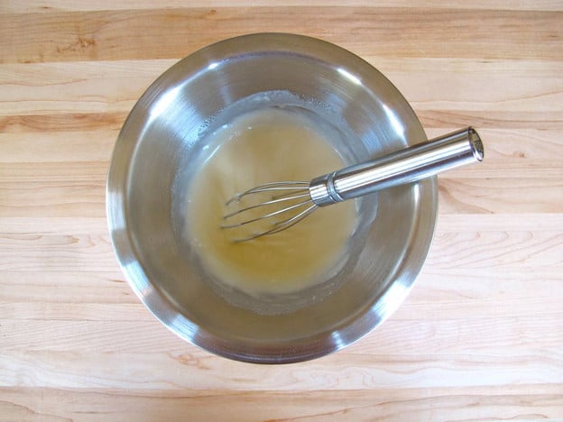 Dressing for salad whisked in a small bowl.