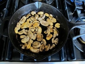 Sliced mushrooms in a skillet.