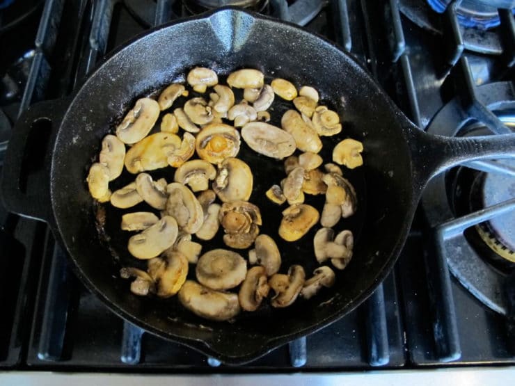 Sliced mushrooms in a skillet.