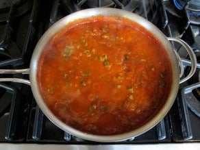 Onions and peppers stirred into tomato sauce.