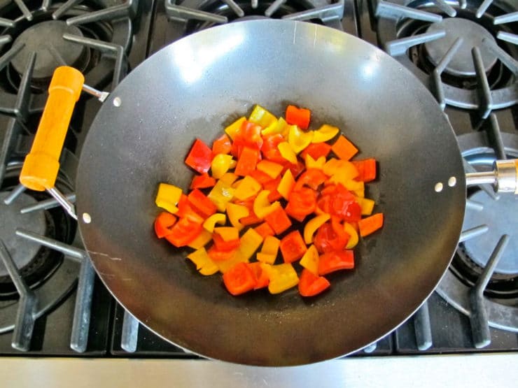 Diced bell peppers in a wok.