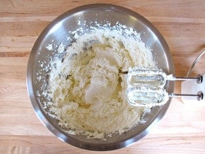 Whip ricotta and cream cheese with a hand mixer in a large bowl.