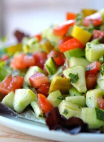 Israeli Salad with Pickles and Mint - Learn the history of Israeli salad and try my recipe, inspired by News Cafe Miami. Kosher, Vegan, Gluten Free, Healthy.