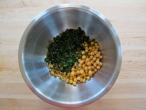 Garbanzo beans and cilantro in a mixing bowl.