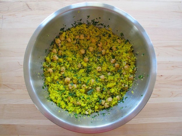 Couscous and garbanzo beans in a mixing bowl.