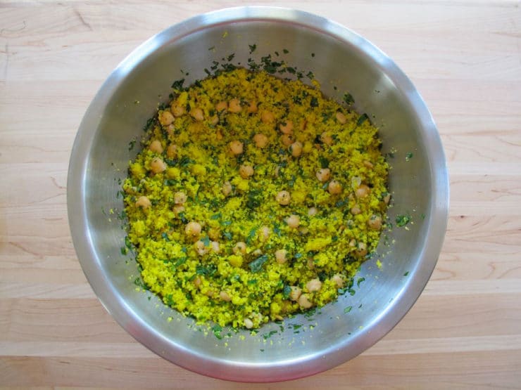 Couscous and garbanzo beans in a mixing bowl.
