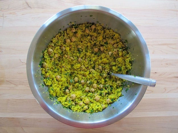 Tossing couscous with lemon dressing.