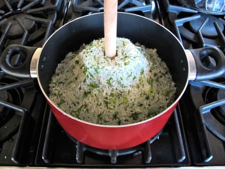 Make a hole in the volcano of rice with the handle of a wood spoon.