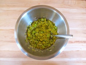 Whisking dressing in a small bowl.