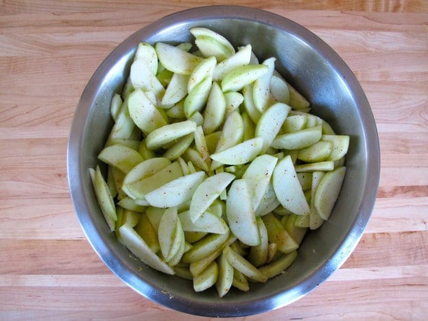Peeled and sliced apples in a bowl.
