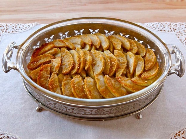 Apple Bread Pudding served on a silver casserole