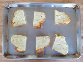 Bread on a baking sheet to toast.