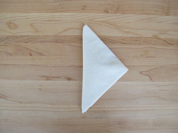 Folded into a neat triangle.