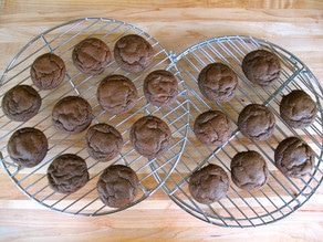 Mini cakes cooling on a rack.