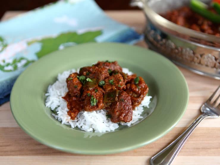 Hungarian Beef Goulash on a sage green plate with fork on the right side.