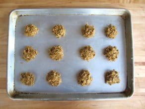 Molasses cookie dough formed into cookies on baking sheet.