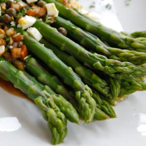 Marinated asparagus topped with chopped vegetables